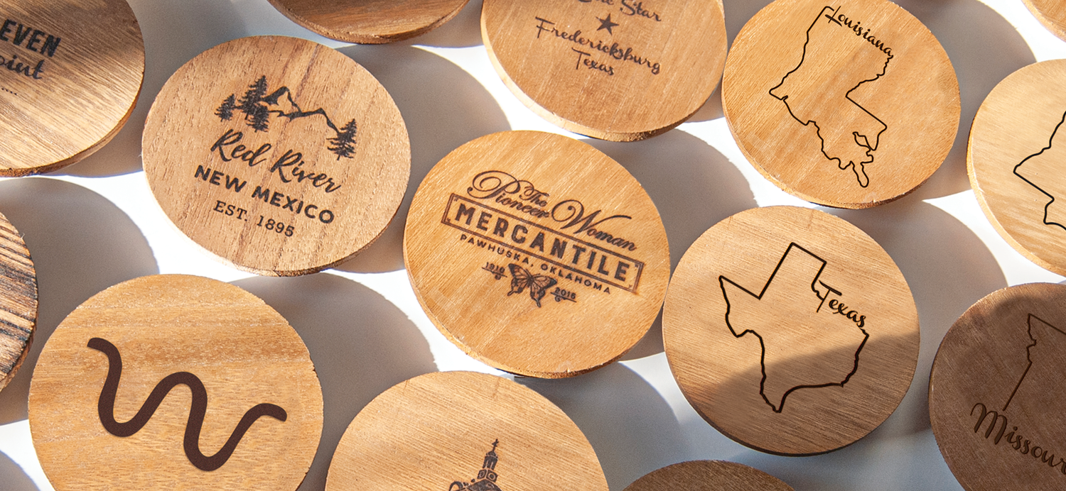 Image of the Private Label Lab custom wooden lids with various logos branded onto the lids